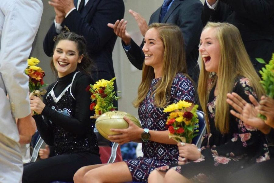 Receiving the golden football, senior Chloe Hershenow is crowned Homecoming Queen alongside the maids on the 2018 Homecoming Court. This was Hershenow’s first time as a maid. “It was really sweet because everyone was cheering and really happy for me and I was kind of in shock,” Hershenow said. “It was really humbling too because it felt really odd to me to be chosen by my classmates [for Homecoming Queen.]”
