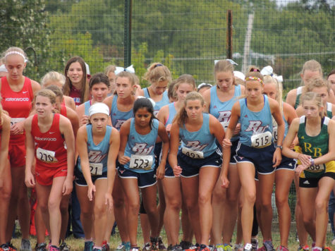 On their marks, the JV squad waits for the gun to sound at the Dale Shepherd Invitational Sept. 29. JV placed first with a team score of 55 points. “I try to get out to the front of the pack pretty early on and from there I pay close attention to the people racing around me, like listening to their breathing and footsteps, and that helps me decide when to make my move,” senior Hannah Rushing said. 