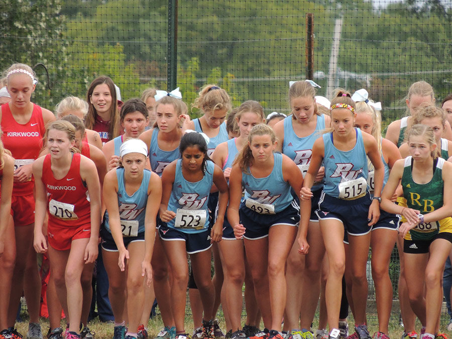 On their marks, the JV squad waits for the gun to sound at the Dale Shepherd Invitational Sept. 29. JV placed first with a team score of 55 points. “I try to get out to the front of the pack pretty early on and from there I pay close attention to the people racing around me, like listening to their breathing and footsteps, and that helps me decide when to make my move,” senior Hannah Rushing said. 