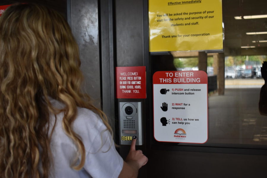 A visitor rings the doorbell as the sign above her tells her what she should expect during the check-in process. Visitors require an identification card and a purpose for the visit in order to be able to check in. “It is a hassle, it’s not as easy to enter the building, but what we have found is that most people are aware of the world that we live in and are willing to spend the extra time,” Mitchell said.