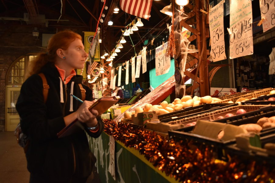 Describing the distinctive characteristics of the neighborhood, senior Nell Jaskowiak strolls through the produce stands at Soulard Market Oct. 25. History of St. Louis students traveled to downtown St. Louis and visited the Old Courthouse, Arch Grounds, Grand Avenue, Lafayette Square and the Downtown Architecture. “My favorite thing that I’ve learned about so far in the class is the diverse cultural backgrounds of all the different neighborhoods in St. Louis, learning about everything from Italian immigrants to the French settlers to the Czechs,” Jaskowiak said. 