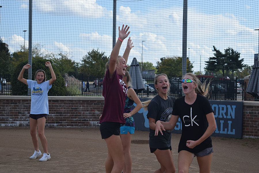 Hands+in+the+air%2C+members+of+the+softball+team%2C+celebrate+together+at+home+plate.+The+team+played+kickball+during+practice+Oct.+5+for+some+team+bonding.+%E2%80%9C%5BAfter+team+bonding+activities%5D+girls+who+I+didn%E2%80%99t+feel+like+I+could+talk+to+before+I+was+able+to+talk+with+because+I+now+knew+we+had+things+in+common+and+could+joke+around%2C%E2%80%9D+Leahy+said.+%E2%80%9CIt+helped+expand+my+friendships+of+the+team.%E2%80%9D