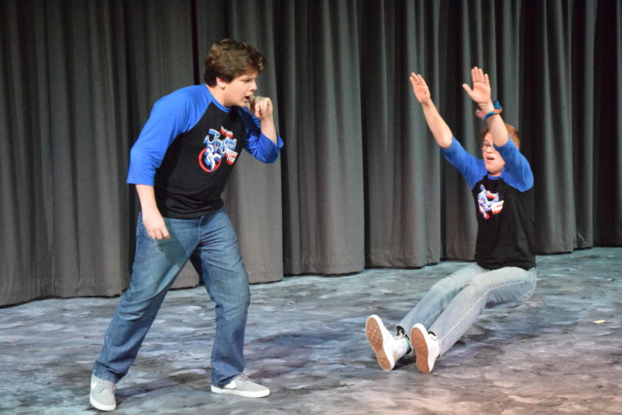 Throwing himself to the ground, senior Hayden Riehl and freshman Ross Harter improvise a scene together. Harter and Riehl were on team “Fashion Disaster” as part of the show’s “Perfect Storm” theme. 