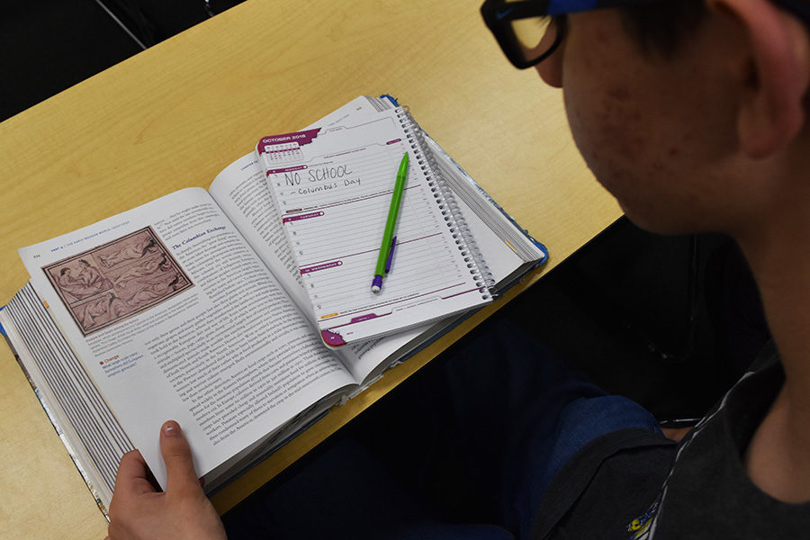 A+student+looks+at+his+planner%2C+which+indicates+that+there+is+no+school+on+Columbus+Day.+Despite+the+fact+that+Columbus+brought+mostly+harm+to+Indigenous+people%2C+many+schools+still+get+off+school+to+celebrate+his+legacy.