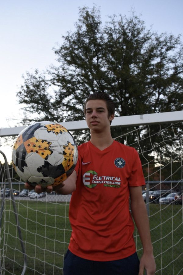 Holding up a soccer ball, junior Jansen Miller dons his soccer jersey in front of a goal. Jansen has played soccer with the St. Louis Football Club Academy for three years. “The advantage is that [STLFC] are good role models, who have helped me not just in soccer, but in life as a professional because thats their job. Thats their life and thats what I want to do,” Miller said. “Seeing them and what they do every single day, thats my goal.”