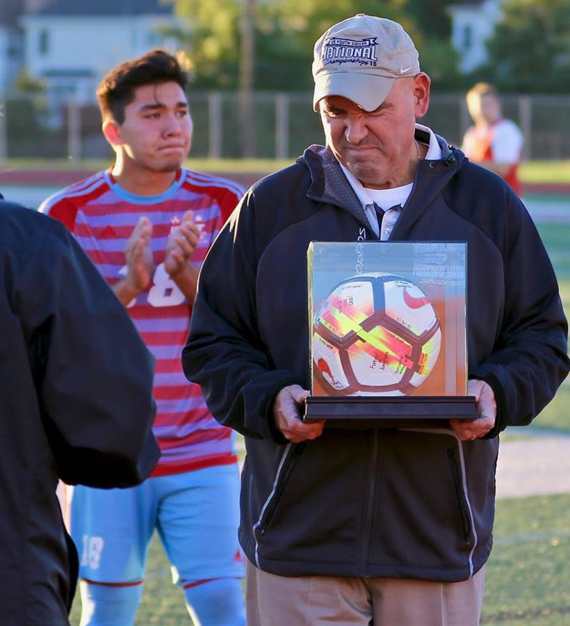 While being presented an award for coaching 11 years on senior night, varsity head coach Michael Skordos and senior Harry Skordos cry for their last home game. M. Skordos has coached his son, H. Skordos, since he was young. “It's really rewarding that my dad has been able to coach me for so long. The fact that he waited until I graduated to retire means a lot, especially that we could spend our last home game together,” H. Skordos said. 