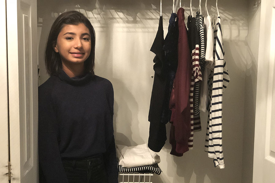 Sophomore Ayesha Malik poses in front of her wardrobe, containing only 10 items. Malik adopted the fashion minimalist lifestyle 1 year ago. I was frustrated with the amount of clothes I had, Malik said. I would always think to myself that I had no clothes, so naturally, I would go shopping for more clothes. This became a toxic cycle.