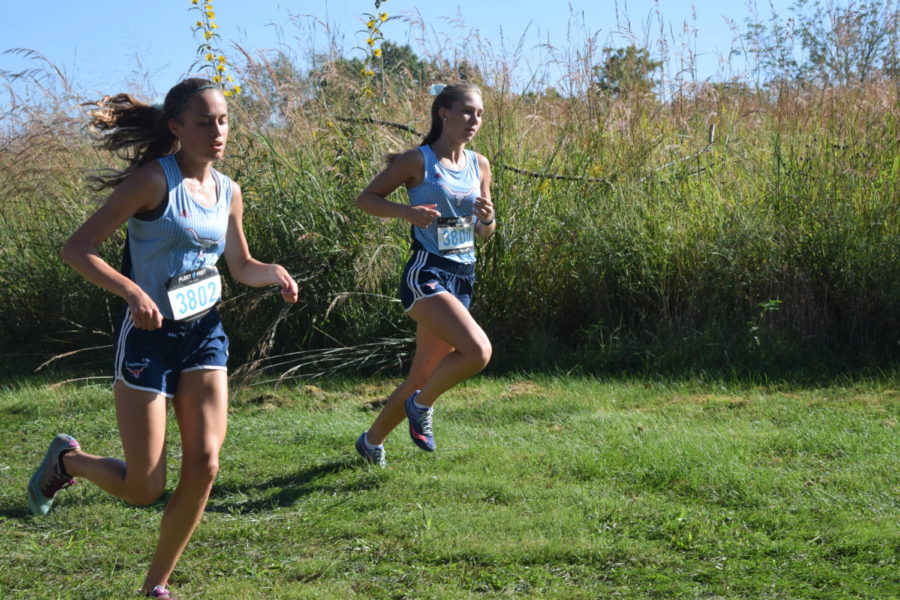 Pacing together, sophomores Leach Selm and Emily Sipp compete at the Paul Enke Invitational at Sioux Passage Sept. 15. Sipp and Selm have both qualified to compete with the state team. "Even if you're having a bad day, the team is always there for you," Selm said. "That's what I love about this sport."