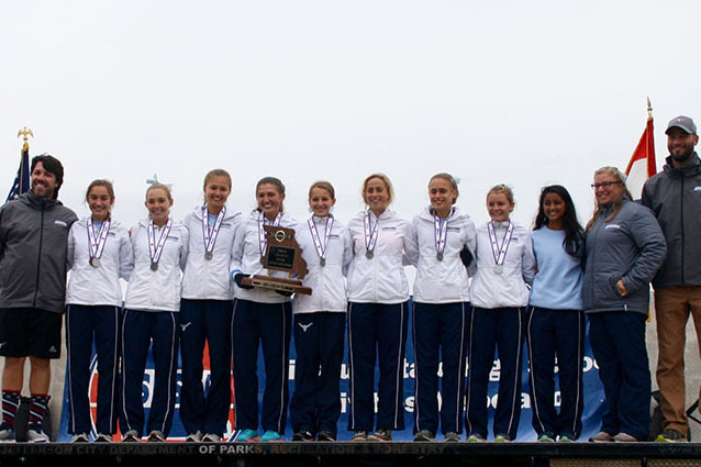 Posing on the podium, the members of the state team receive the second place trophy. This was the team’s first all-state performance since 1990. “It was a huge step forward for us.  We were always on the outside looking in at all major meets,” coach Charles Cutelli said. “We slowly knocked down barriers, winning conference championships, district championships, and sectional championships, and finally having an all-state finish. I’m proud of this group.”
