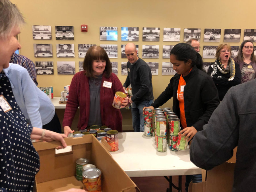 Sorting+through+canned+goods+Nov.+19%2C+freshman+Brinda+Ambal+participates+in+the+West+County+Interfaith+Alliance+Thanksgiving+drive.+Members+from+the+Hindu%2C+Islamic+and+Jewish+temples+came+together+alongside+Catholic+and+Christian+church+members+to+better+understand+each+others+faith+and+provide+canned+food+for+the+Parkway+Food+Pantry.+%E2%80%9CIn+a+world+where+there+is+so+much+religious+conflict%2C+it+is+really+great+to+see+people+come+together%2C%E2%80%9D+Ambal+said.