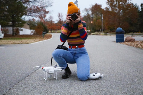 Posing with her camera and drone, junior Caroline Judd shows the equipment she needs to continue her career as a photographer. Judd used her own money to purchase her equipment and uses her own time to take and edit photos. “I’ve invested lots of money into camera equipment and editing software that you can’t get at school,” Judd said. “I understand that that isn’t a priority for the school, but it’s hard when you want to follow a career that isn’t typical or STEM focused because you have to put so much time into outside of school while also balancing your schoolwork.” 