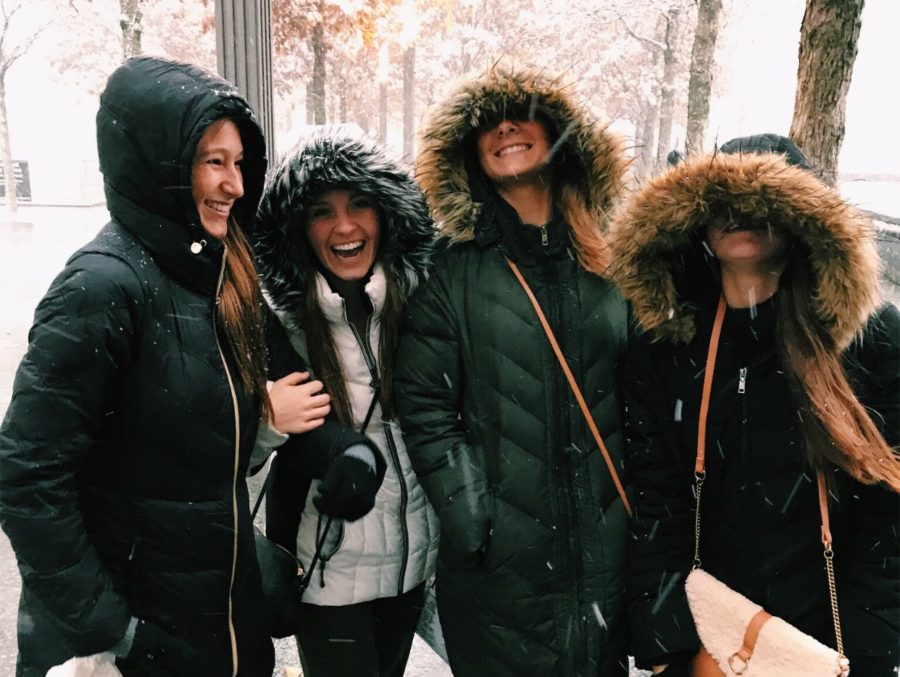 Smiling through a sudden snow fall, juniors Caroline Briscoe, Reagin Ward, Jenna Mercer and Madison Foelsch put their hoods up as they navigate through the streets of New York. Marketing students arrived in the city Wednesday to attend seminars, shop and explore. “I was already so excited for a day with my best friends, but when it started snowing is when I really felt like I was in a movie,” Mercer said.