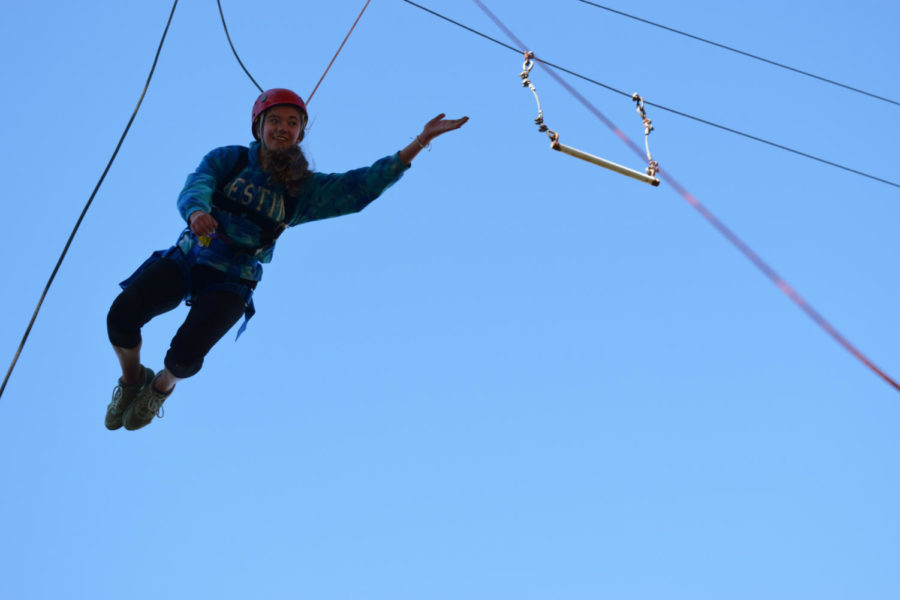 Soaring through the air, sophomore Sarenna Wood takes on the Parkway North ropes course, part of the Adventure Pursuit field trip Oct. 29. The students jumped off tall platforms and attempted to grab trapeze bars. “It was terrifying actually, getting on top of it was the hardest part, it was all adrenaline and you didnt feel anything else,” Wood said.