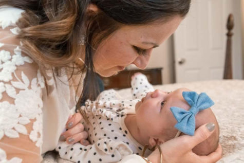 Tricia LaRocca Morris holds her newly adopted daughter, June Caroline. Morris, working as a Neonatal Intensive Care Unit Nurse, helped tend to sick newborn babies everyday while attempting to adopt. “We are just so grateful for our little girl, June Caroline, that its hard to fathom that someone else is grateful for us. I think thats part of what makes a successful adoption so special. It is the answer to so many peoples prayers,” Morris said.