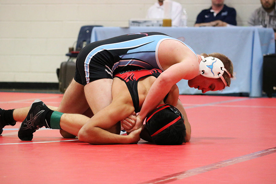 Competing in a 2017 wrestling match, junior Reed Nenonen performs a cradle on his opponent. Nenonen went on to have a 16-10 record and advanced to conference semifinals. “All I can hope [for this season] is that I can push myself and make the team what it can be,” Nenonen said.