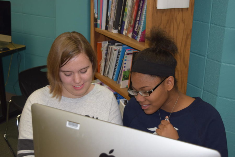 Providing each other feedback, alumni Sydney Kinzy and Gabrielle Thompson revise fiction stories they wrote. Both were members of the literary magazine production club, Reflections, which met once a week on Mondays. “Any clubs that took place before school or on Fridays, I had no possible chance of participating in them due to either the city buses showing up too late to school or there being no transportation available at all,” Thompson said.