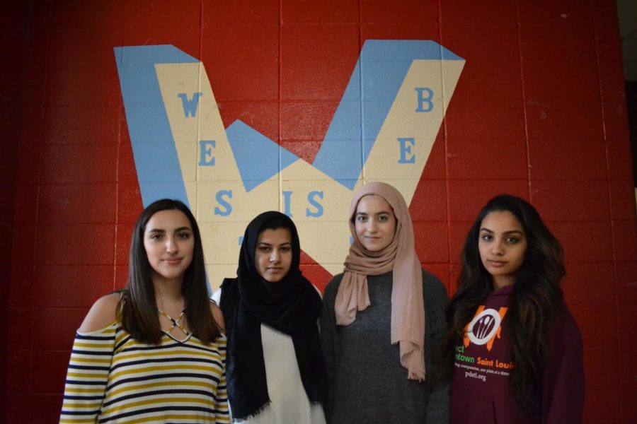 Staring ahead, sophomores Camila Angulo, senior Hira Khan, sophomore Ulaa Kuziez and senior Kinza Awais stand together at school. Although they feel mostly accepted at school, they face discrimination at times due to their religions and identity as immigrants. “It doesn’t happen as much at West, but I definitely get it sometimes where it doesn’t happen to my face. I’d rather have people say it to my face, so I can give them a chance to explain themselves, and I can have a chance to explain myself,” Khan said. “I’ve heard behind my back, whether I’m sitting in class, or just in the halls, that someone either will point out that I look different or has said something to me. I’ve definitely gotten a lot of terrorist jokes made at me.”