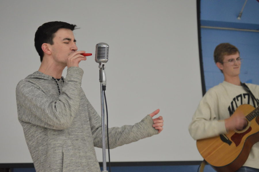 Senior+Noah+Wright+performs+a+kazoo+solo+at+the+Pwest+for+Flint+benefit+concert.+The+concert+was+held+by+the+Honors+Environmental+Sustainability+class+to+raise+money+for+the+victims+of+the+Flint%2C+Michigan+water+crisis.+%E2%80%9CPlaying+kazoo+was+a+fun+and+unique+way+to+spice+up+our+music%2C%E2%80%9D+Wright+said.+%E2%80%9CI+wanted+to+contribute+in+whatever+way+I+could+to+the+people+of+Flint.%E2%80%9D
