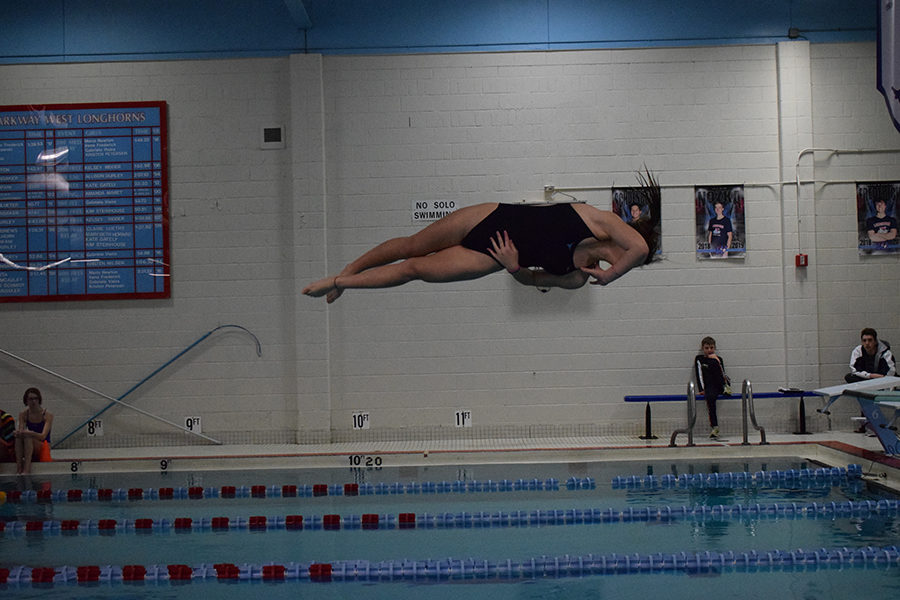 5:11 p.m.
In midair, junior Claire Lynn completes a one and a half twist dive at a home meet Thurs., Jan. 10. With swim and dive conference and state coming up, Lynn used this meet to practice higher level dives. “I’ve been working on some new dives to work up to conference and state, and I did them all, so I was happy about that. Right now, I’m just trying to improve them to get a state cut,” Lynn said. “I went to state last year, but I was one of the last people to get accepted, so I’m really looking forward to going back, improving my place and being more competitive with the other divers.”