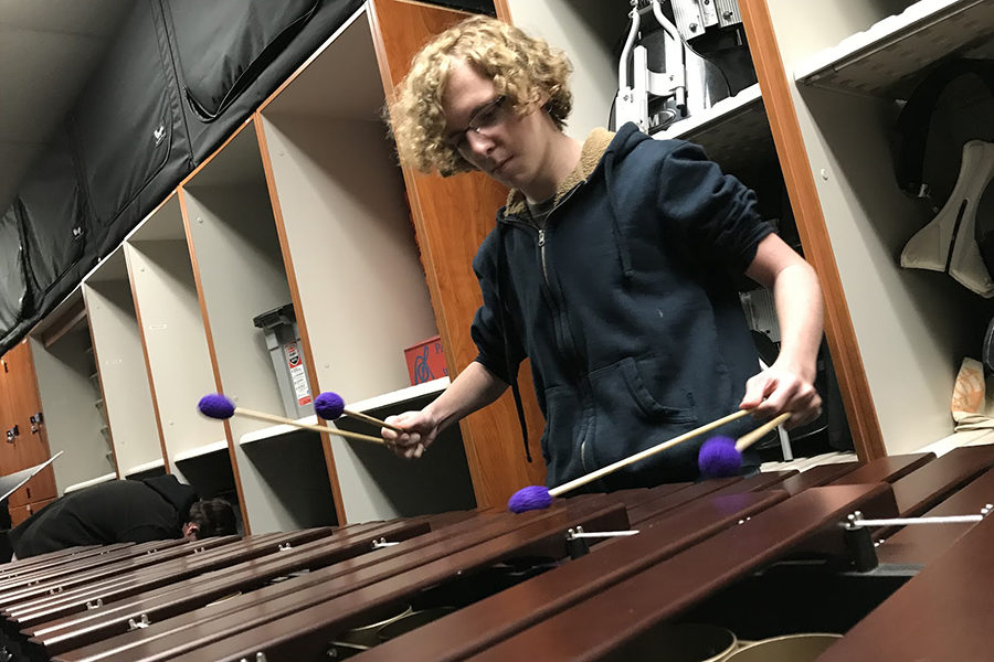 7:19 a.m.
As cars pull into the parking lot, senior Ryan Crowley practices his marimba solo in the band room storage closet. Crowley is preparing “Parody,” by Jesse Monkman, for the district Solo and Ensemble–a contest he has participated in for the past three years. “[Practicing] gives me something productive to do in the morning because the percussionists, we can’t take our instruments home, so you have to find time to practice whether it’s before or after school,” Crowley said. “It can be relaxing if you treat it the right way, and it’s a nice way to start the day.”
