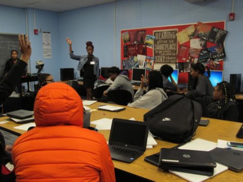 As students raise their hands, president Kyra Clerk leads a meeting to discuss the positives and negatives of attending a Historically Black College or University (HBCU) or a Predominantly White Institutions (PWI). Students were called out of class during school hours to attend the meetings. “ASAP empowers me to do better in school but I like to think that I was already doing well,” Clerk said. “I feel like it kind of gave me a push to continue being a role model for my underclassmen;  I’m the president so when they look at me, I want them to be able to say, ‘My president is studious. She’s there for me and she’s also very helpful.’”