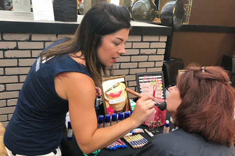 Spanish teacher Lauren Bernstein promotes SeneGence tinted lotion to potential customers. After this year, Bernstein will be leaving the education field to pursue sales for these cosmetics. “This really provided an opportunity for me,” Bernstein said. “I do [feel empowered], both on the business sense of things and [the personal].”