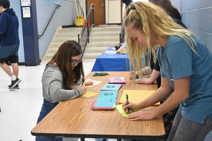 Stopping on their way into lunch, students write letters for the students of Marjory Stoneman Douglas High School. Students were given the opportunity to write letters the week of Feb. 4-8. “The goal in doing this is to make the students at Parkland feel love and support as they’re approaching the one year anniversary of this difficult time,” senior Sophie Pellegrino said.