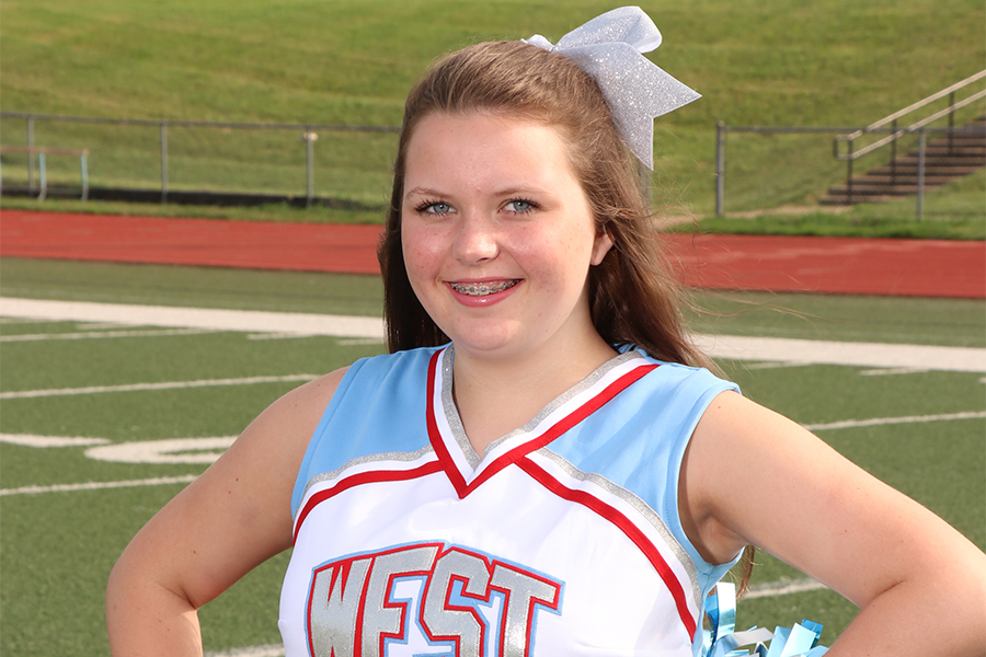 Freshman Meg Gardner stands on the football field before cheerleading practice after school. She is excited for the upcoming season and plans to improve. “Cheerleading was always an inspiration to me and I am glad to continue it,” Gardner said. 
