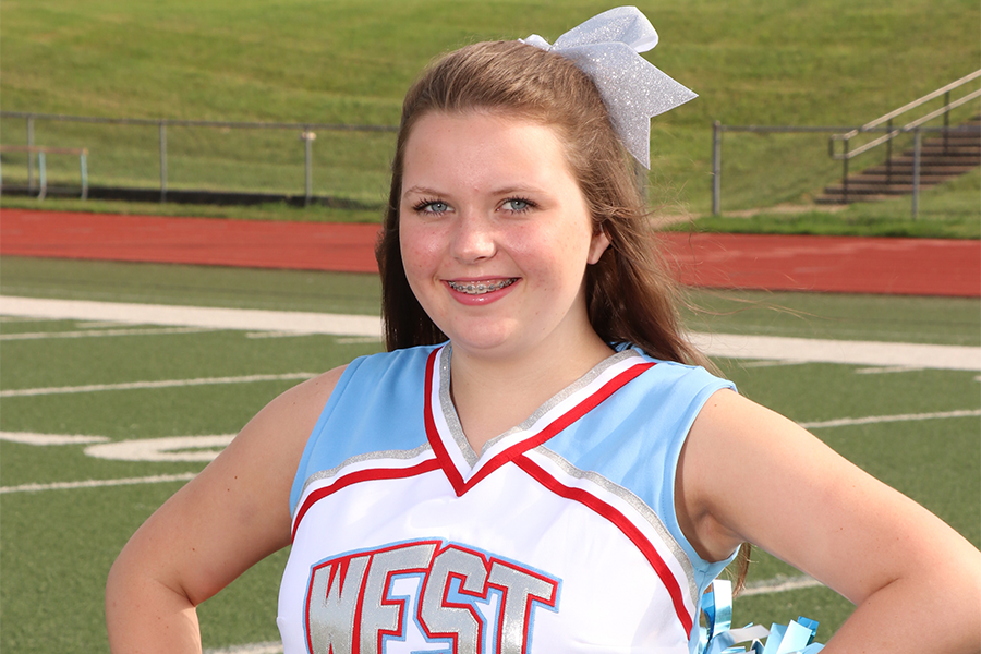 Freshman+Meg+Gardner+stands+on+the+football+field+before+cheerleading+practice+after+school.+She+is+excited+for+the+upcoming+season+and+plans+to+improve.+%E2%80%9CCheerleading+was+always+an+inspiration+to+me+and+I+am+glad+to+continue+it%2C%E2%80%9D+Gardner+said.+%0A