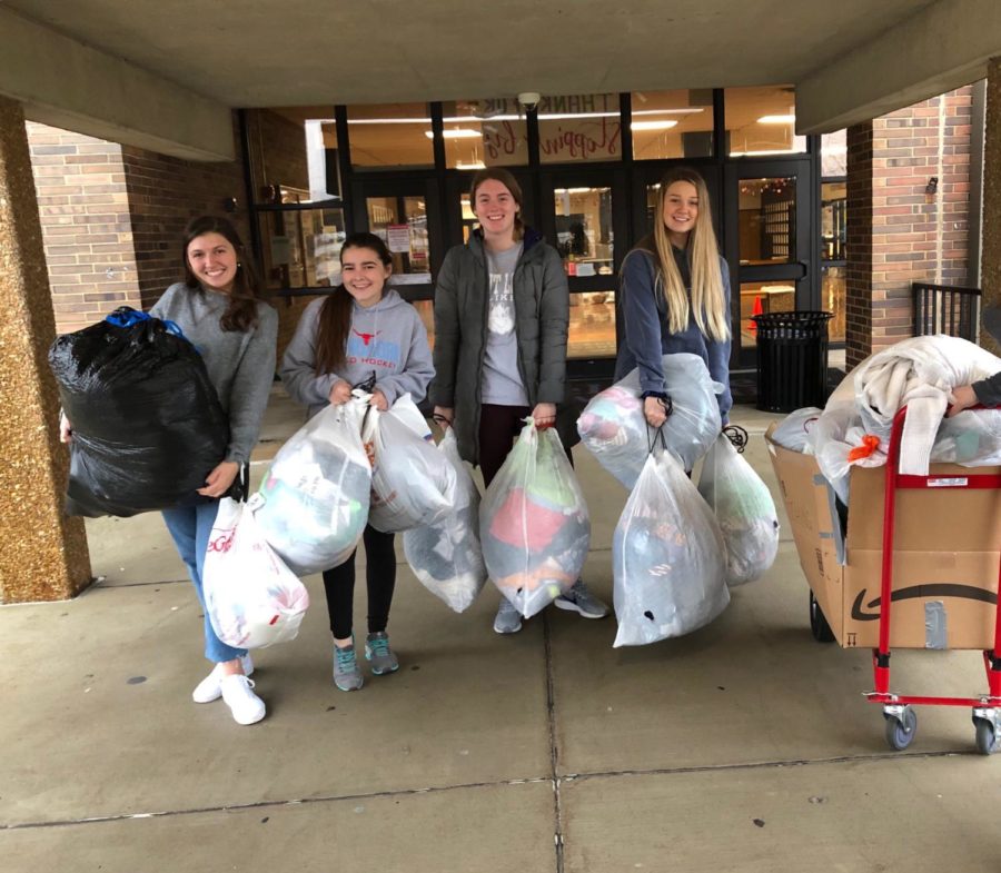 Juniors Lily Stiegemeyer and Emma Caplinger and seniors Olivia Riemer and Hayden Sampson,  are carrying bags to the truck to load donations for St. Clair high school. Bags are being carried down and loaded onto a truck  to be taken to kids in need. “In the morning at 7am, we carried  the bags down to the main floor, and they were all heavy. Klevens asked some of the guys that were sitting in the Art Foyer  to help us carry down the bags do it went a lot faster.”Yearbook Editor -in-Chief, senior Olivia Riemer said.