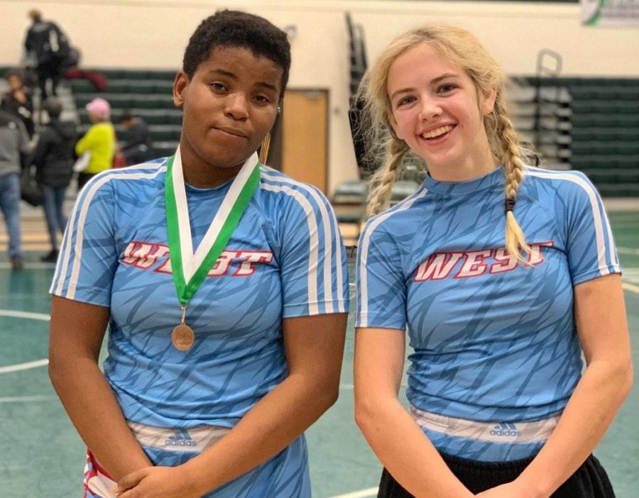 Sophomore Emma Carter and freshman Paige Wehrmeister pose together after the Mehlville Women’s Invitational Dec. 21. The tournament was the first girls tournament that either one had been to; Carter took third place in the 167 pound weight class, and Wehrmeister took fifth in the 121 pound weight class.