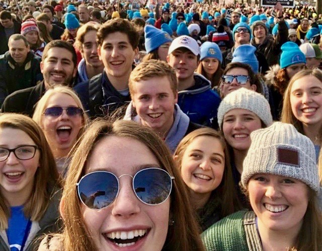 Followed by thousands of other marchers, junior Emily Weaver and sophomore Molly Reinecke smile with their youth group as they participate in March for Life 2019. The march followed speakers and activists from across the country all expressing support for the cause. “There was definitely a lot adrenaline throughout the march because everybody there was so passionate,” Reinecke said.