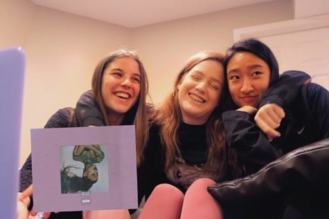 Students smile before reacting to Ariana Grandes new album.