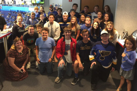 Kelly Quinn, standing to the left, poses with Best Buddies at a Pre-Season St. Louis Blues game hosted by St. Louis Blues Alumni. This opportunity helped members of Best Buddies strengthen their friendships through a shared passion for hockey. “[I love] witnessing two people click as friends,” Quinn said. “It is like watching magic or seeing someone truly come to life. The joy from seeing others feel joy is extremely powerful.”