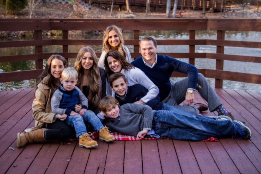 The Morgan-Hopkins family sits together for a group photo. The family of eight lost their home to a house fire Feb. 2.  This makes you realize the little things in life that you don’t even realize you are blessed with, as simple as a toothbrush, a change of clothes, toiletries, food or personal and memorable belongings. Always appreciate what you have been given, alumna Madison Hopkins said. 