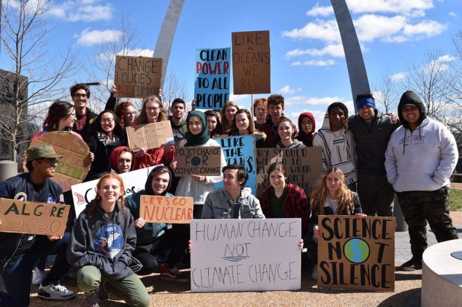 26 of the 30 West students who attended the Youth Climate Strike US in St. Louis pose for a picture under the arch. The national walkout was for young people to voice their discontent with inaction in the government regarding climate change. [I decided to come] because the world is dying, senior Lizzy Calvert said. We need to be careful.