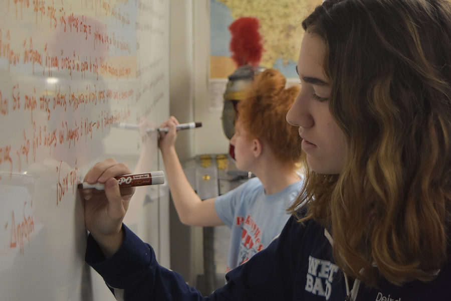 Writing Greek prose on the whiteboard, seniors Nell Jaskowiak and Deirdre Jost practice their letters and accents during their independent study. Taking Greek enables Jost to better prepare for a variety of possible futures, both through the content itself and the skills she retains. “Greek actually has a whole bunch of different accent marks which is not something you have in English,” Jost said. “I feel like Id like to take [another] language, maybe Spanish or French,  in the future and having learned the Greek language with different alphabets and different accent marks might make it easier to learn that language, whatever it may be.”