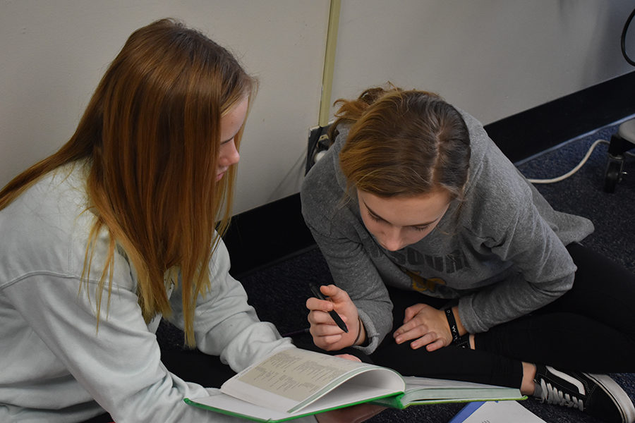 Translating a story from their textbook, freshmen and Latin II students Mary Hardy and Claire Folkins work together. The practice translations in the textbooks follow a story of the same characters throughout the four books. “I chose latin because both of my sisters took it and they both really enjoyed it. Also because they both said Herpel was the best teacher,” freshman and Latin I student Claire Folkins said. “Our class is really close and we all get along really well. We can joke around with each other but also get work done when it needs to get done.”
