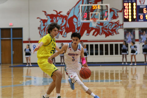 Putting his arm up to block the defender, junior Kyle Geraghty drives to the hole to score a basket.Geraghty averaged 6.7 points per game on 37.4% field goal shooting this season. “It’s been a rough season. At the end of the day, it was all about making relationships with the guys and the experience you’ll look back on in high school,” Geraghty said. “Even though our record doesn’t show it, I’ve had a good time this season.” 