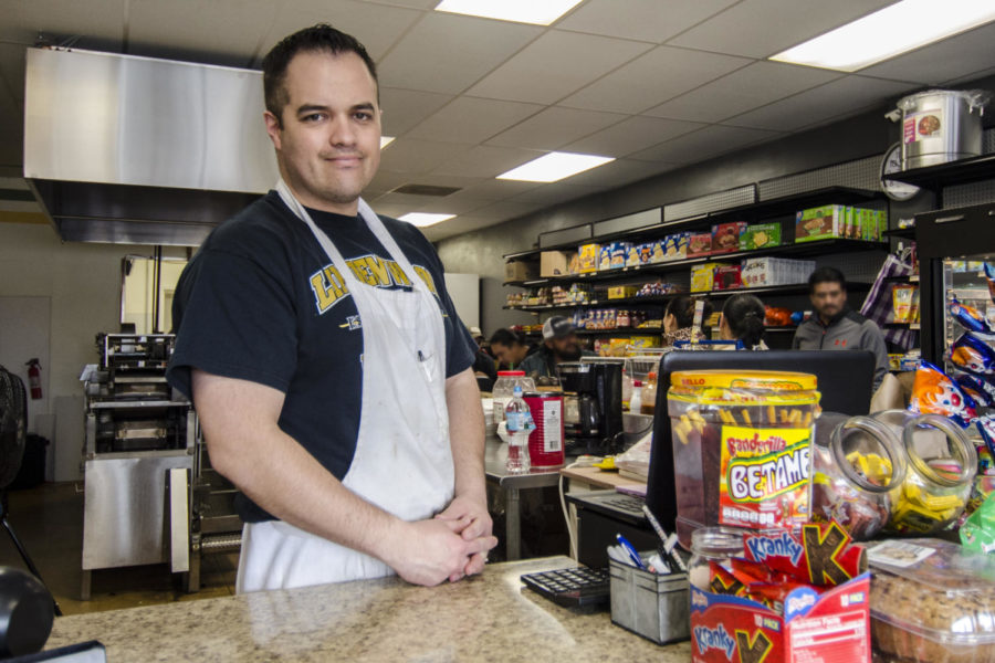 Officer Zeus Hernandez stands at the counter of his restaurant La Tiendita, located at the corner of Clarkson and Manchester. He and his wife own the restaurant, which sells authentic Mexican cuisine along with groceries. 