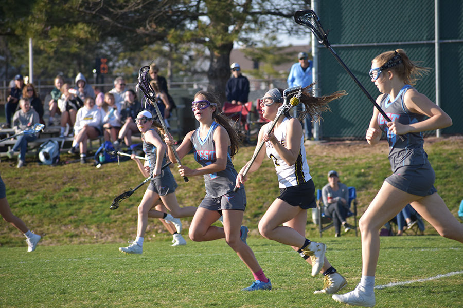 Stick in the air, junior Charlotte Zera follows the ball in a varsity game against Lafayette April 2. Zera first started playing lacrosse when a tennis teammate encouraged her to try out for the team. “The kind of culture I hope to inspire in the lacrosse program is one where everyone can freely make friends and help each other grow not only in lacrosse, but in their character, sportsmanship and athleticism,” Zera said.
