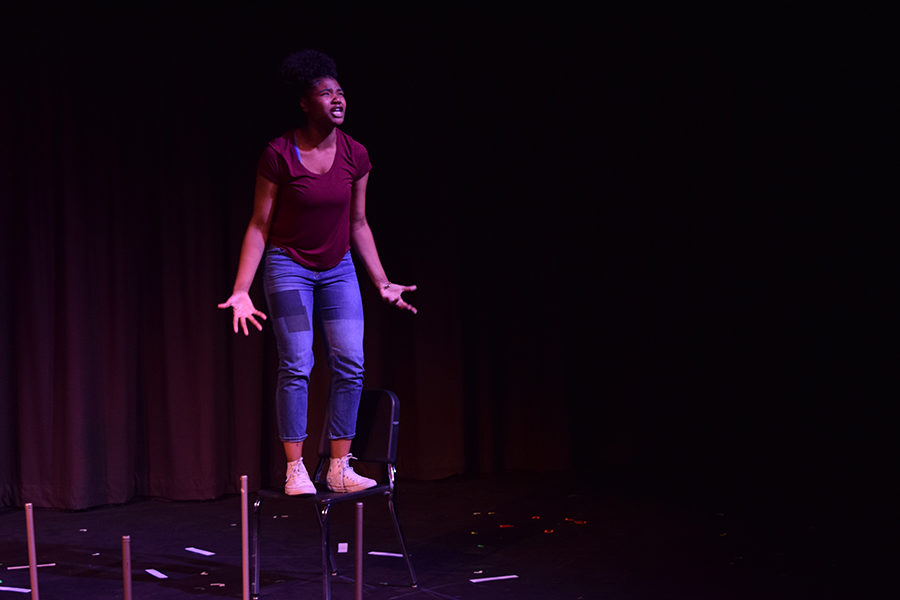 Gesturing to the audience with open arms, junior Aaliyah Weston plays the character Two in one act play "The Dreaming" April 17. The one acts were directed by seniors in Amie Gossett's Directing class and took place in the theater April 17 to April 18. “Theater is important to me because it’s a chance to break out of everything I do on a day to day basis, and it generally just makes me happier,” Weston said. 