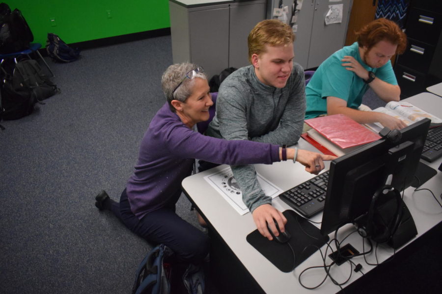 Business teacher Laura Glenn helps junior Walker Piles with an assignment in class. Throughout her time of teaching, Glenn has taught Accounting, Web Design and Intro to Computer Science and Technology. “The thing I’ll miss the most is working with students and sharing knowledge with them,” Glenn said. “[It’s] really exciting to see how just a little bit of what I might’ve introduced them to here has turned into a career for them and something that they are excited about.”