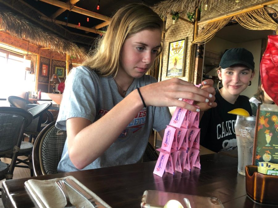 While waiting for her Caesar salad to arrive, sophomore Emma Breidecker entertains the table with her Sweet and Low Tower. Breidecker traveled to Anaheim for the National High School Journalism Convention. “I was really nervous because I was just doing it while I was waiting for the food to come and then everyone started watching. I felt so much pressure,” Breidecker said.