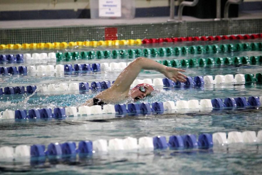 Senior Maria Newton swims during her practice competition at Marquette Relays during the start of her season. The swim meet is a long standing tradition for St. Louis area high school teams to participate in low-stake competitions. “It was always one of my favorite swim meets because I love to be reminded that the sport is about racing, and that is what we need to be focused on,” Newton said. “You just need to be faster than the person next to you.”