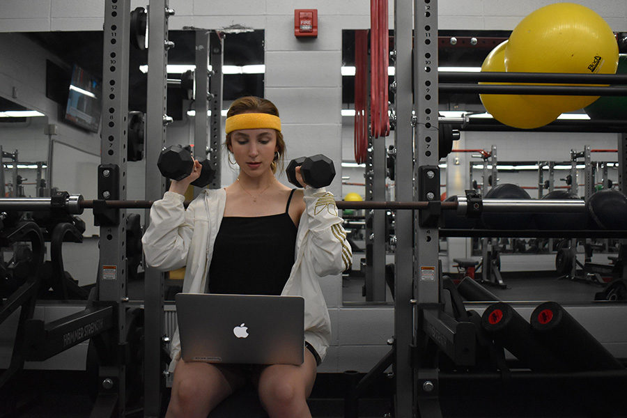 Junior Caroline Judd attempts to follow an online weightlifting video. In the summer of 2020 Parkway is introducing a new online physical education course available to all students.