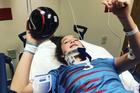 Freshman Ella Roesch lays in a hospital bed in the emergency room during the varsity game against Nerinx Hall, April 12. Roesch was hit during the game, and was rushed to the hospital. “I was scared that I was going to be seriously hurt. But when the CT scan came back negative, I was extremely relieved,” Roesch said.