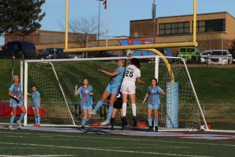 In a soccer game against Nerinx hall, senior Ashton Manwill goes up for a head ball off a corner kick. The girls varsity soccer team beat Nerinx Hall 2-1. “I was really excited because in all my years of playing Nerinx it was the first time we have ever beat them, which was just the best feeling,” Manwill said.