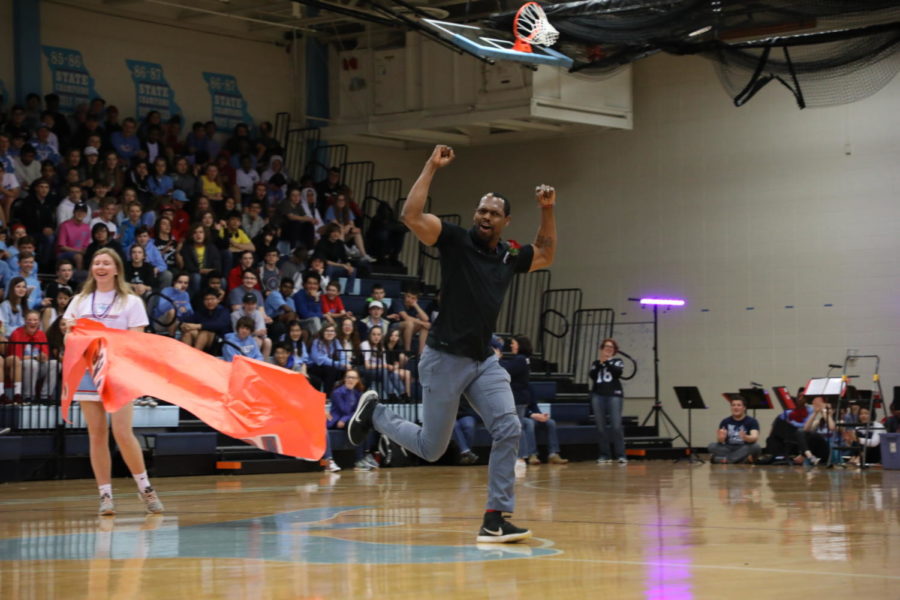 Beginning his victory lap around the gym, 2019 Teacher of the Year awardee Emanuel Young pumps his fists to energize the crowd at the Spring Pep Rally, March 29. This is Young’s fourth year teaching business at West High.. “I was in a state of disbelief,” Young said. “My heart was racing; it was one of those things you felt like you should have known but didn’t.”