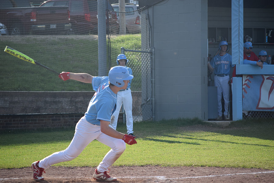 Finishing his swing, senior outfielder Jackson Barnhart gets a base hit to centerfield. Barnhart and his fellow “troops” defeated Ritenour High School on their senior night 18-2. “I like to be the trendsetter. I like to pick our guys up while we are down, and I like to just have fun with it,” Barnhart said. “I specifically remember this game I was having more fun playing than usual because it was my last senior night, and I was dancing and singing in the outfield, just doing my best to help us play better.” 